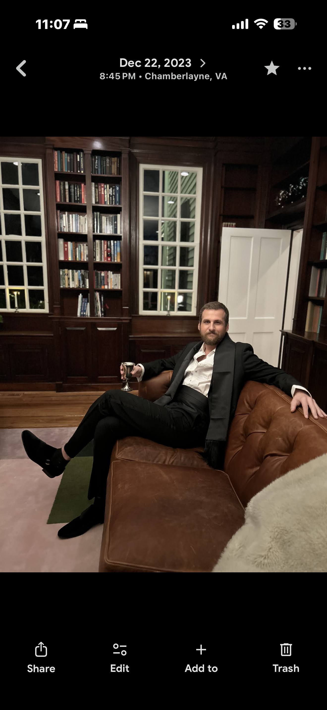 Randy Bryan Moore seated in a library wearing a black suit